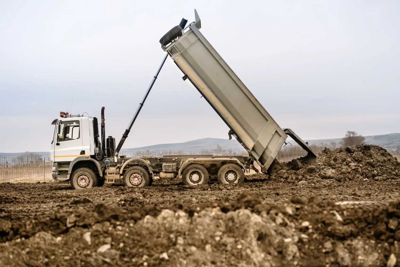 Bulk material hauling truck for topsoil delivery in Oklahoma